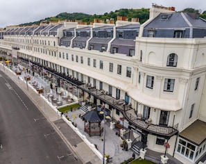A row of white buildings with balconies, a street in front, and a gazebo. - Dover Marina Hotel & Spa, Tapestry Collection by Hilton (Dover)