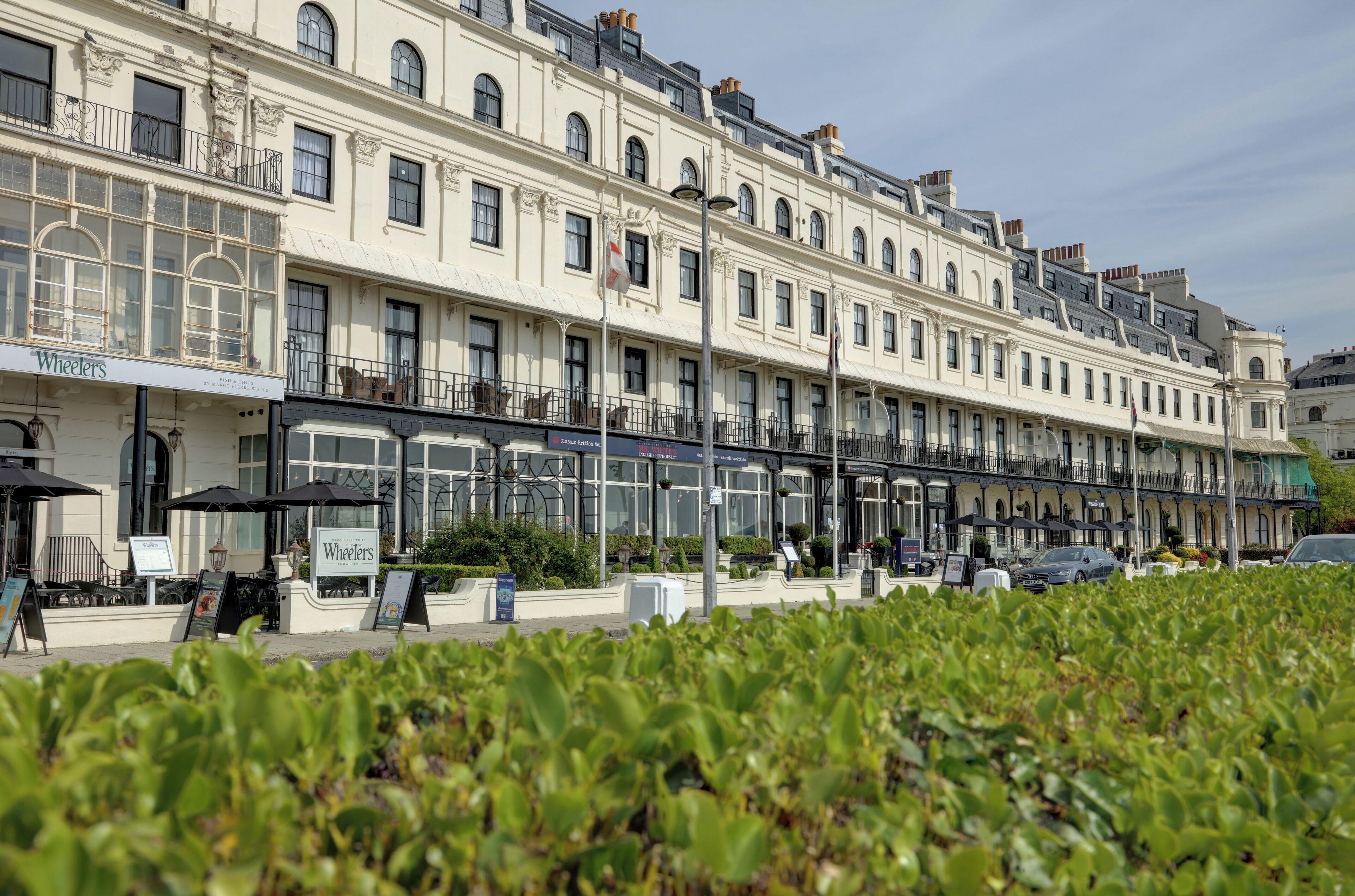 A row of classic European-style buildings with a restaurant named "Wheelers" on the ground floor.