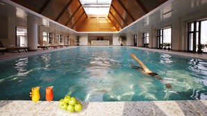 An indoor swimming pool with a high ceiling, clear glass ceiling, and a tiled floor. - Sunrise on the Bund (Shanghai)