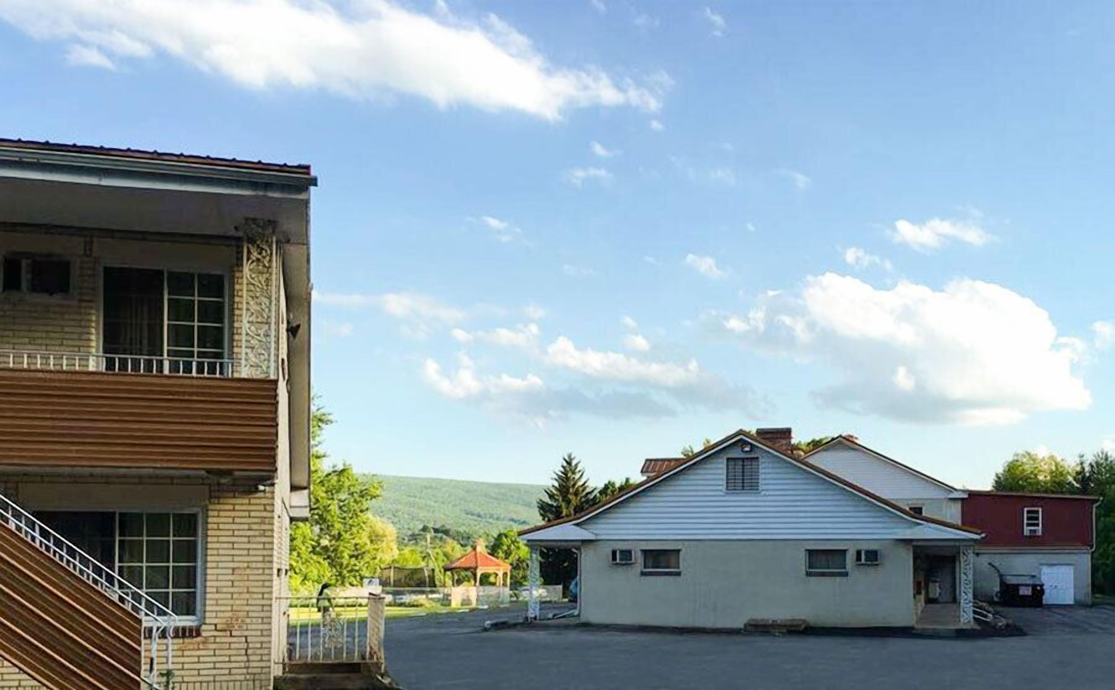 A two-story building with a balcony and a garage.