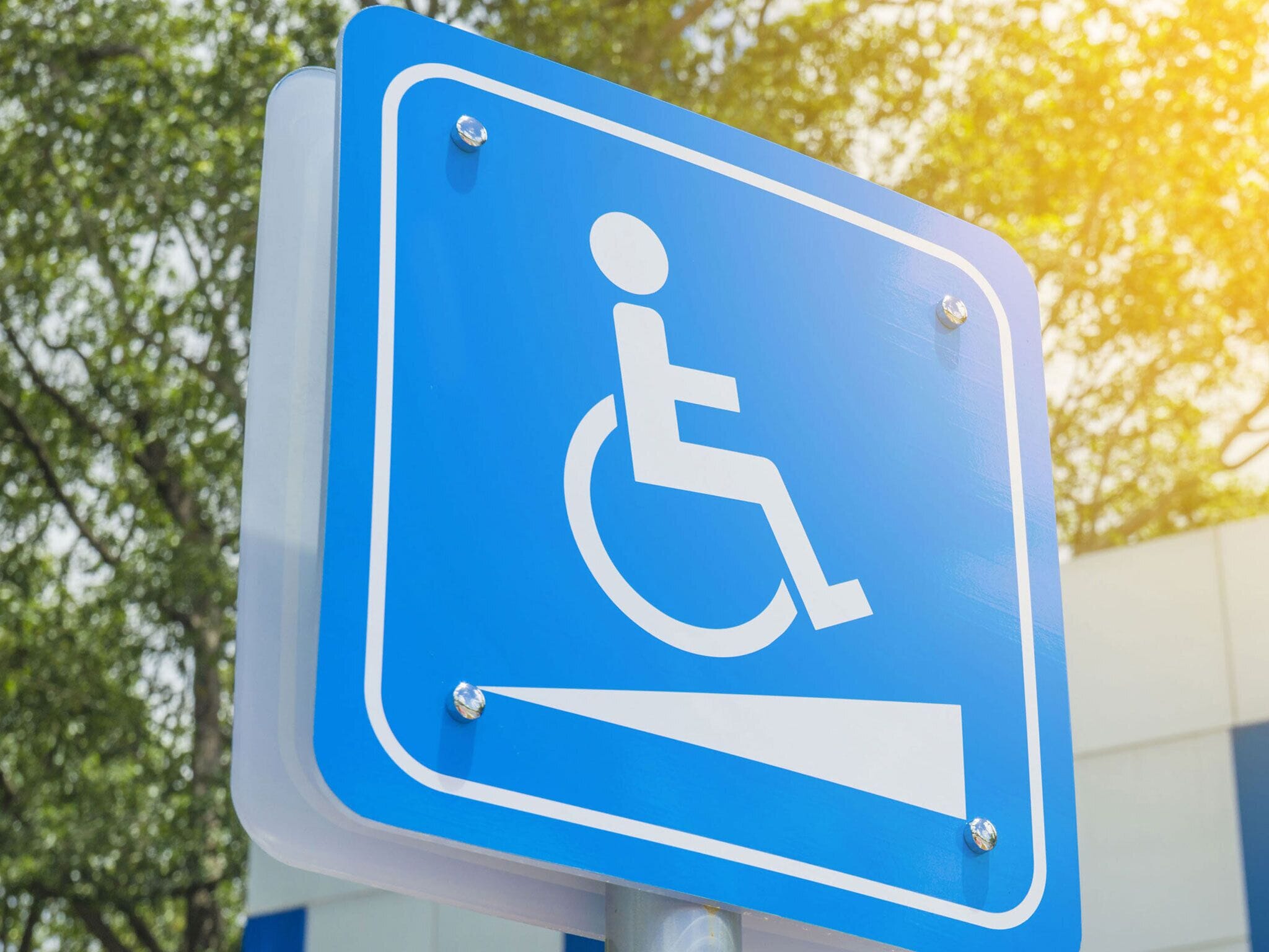 A blue handicap parking sign with a white wheelchair symbol.