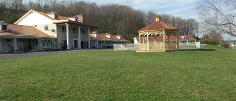 A building with a covered porch and a small pavilion.