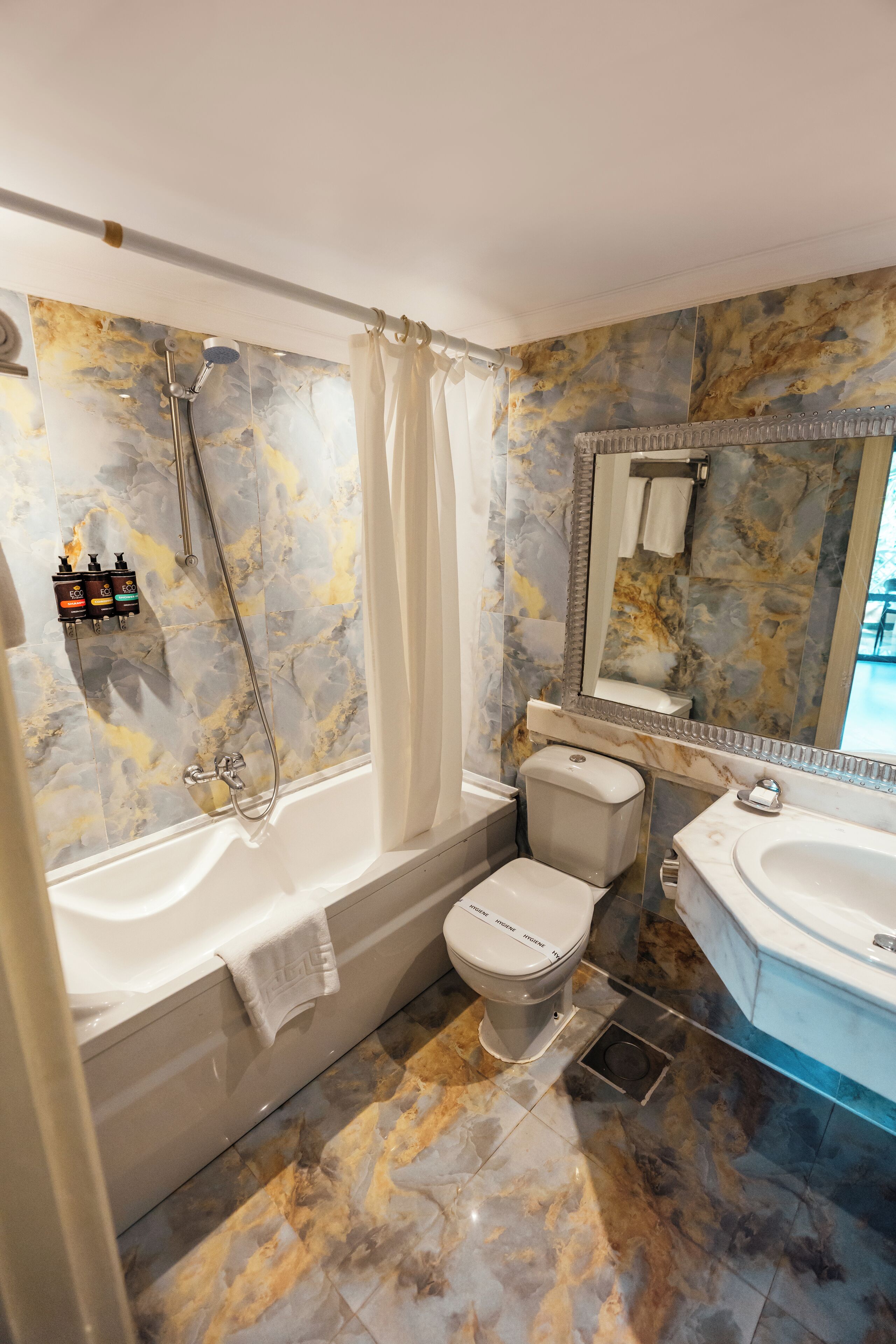 A bathroom with a bathtub, toilet, and sink.