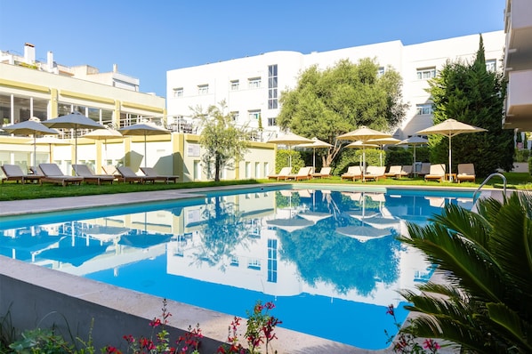 Seasonal outdoor pool, open 11:00 AM to 7:00 PM, pool umbrellas