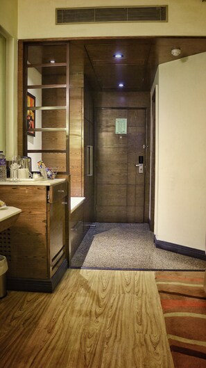 An elevator with a wooden panel design, a small sign above the door, and a carpeted floor. - Hotel City Park Airport (New Delhi)