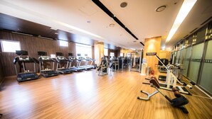 A gym with treadmills, weight machines, and a wooden floor. - Holiday Inn Gwangju by IHG (Gwangju)