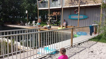 Una piscina al aire libre de temporada, sombrillas