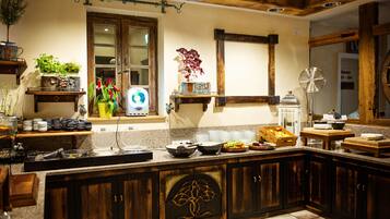 A kitchen with wooden cabinets, a granite countertop, and various kitchen appliances.