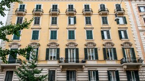 A multi-story building with evenly spaced balconies and a consistent architectural style. - El Dorado Vatican (Rome)