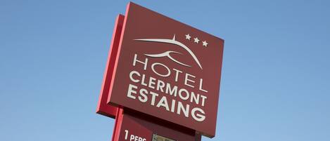 A sign for Hotel Clermont-Estaing with a price display for 1 person at 12 euros and 2 persons at 17 euros.