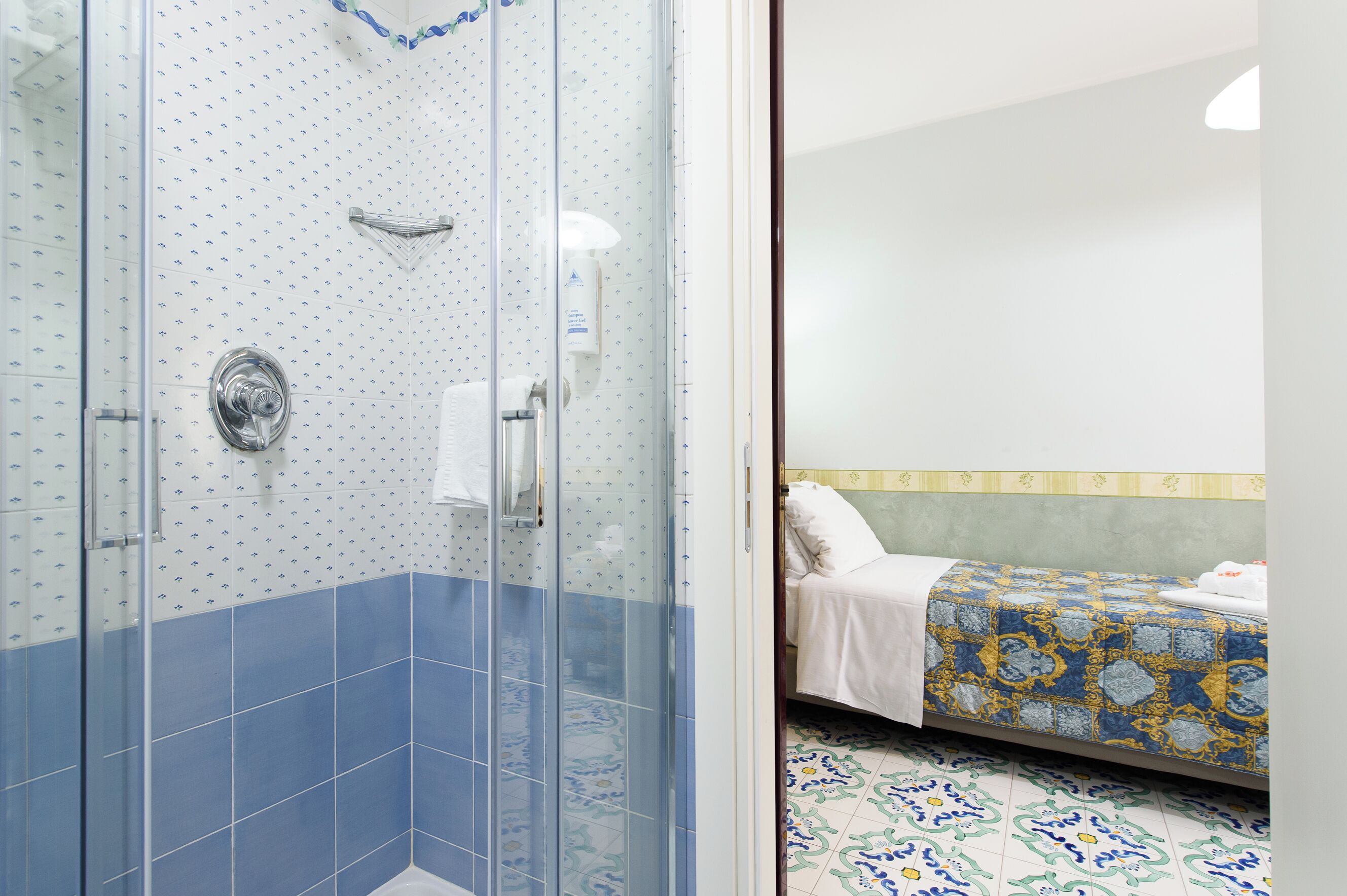 A bathroom with a shower, a toilet, and a sink.