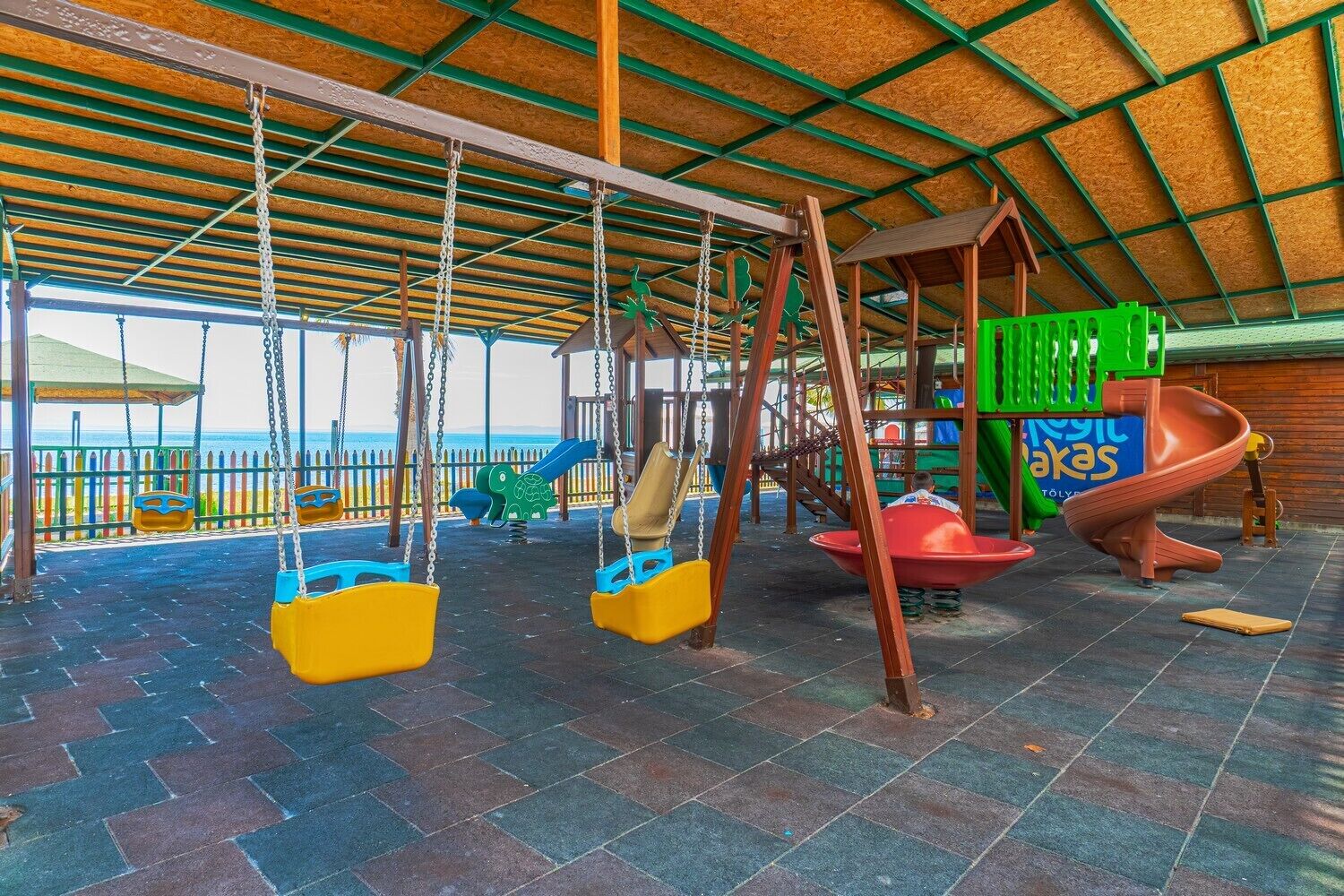 A playground with swings, slides, and a climbing structure.