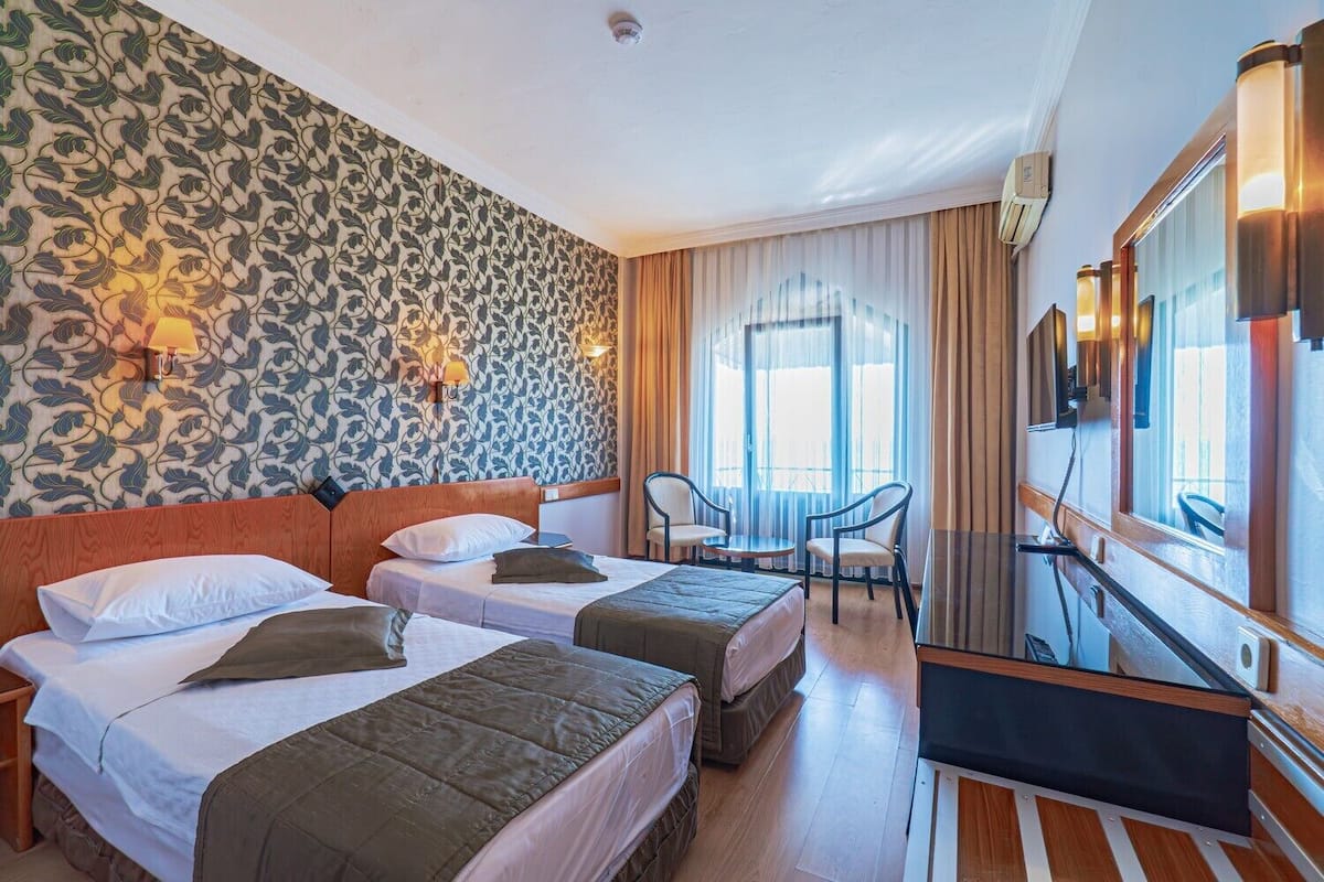 Standard Room, Sea View | Minibar, in-room safe, desk, laptop workspace