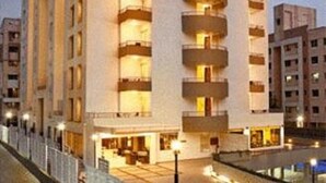 A modern hotel with multiple floors, balconies, and a central courtyard. - Cocoon Hotel (Pune)