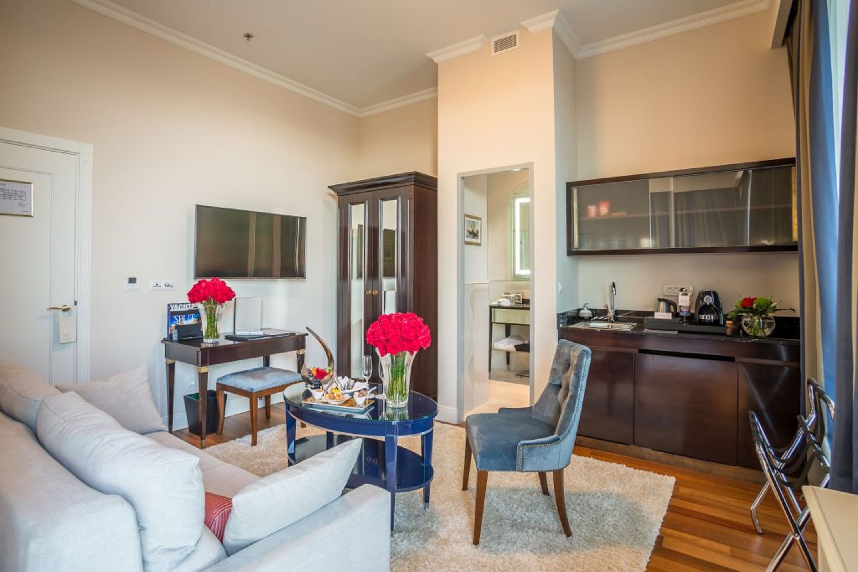 Una sala de estar moderna con un sofá, una mesa de centro y un comedor con una silla y una mesita.