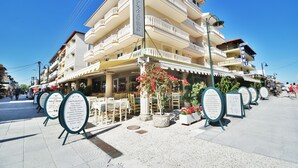 A multi-story hotel with outdoor seating and a clear blue sky. - Parthenon Art Hotel (Katerini)