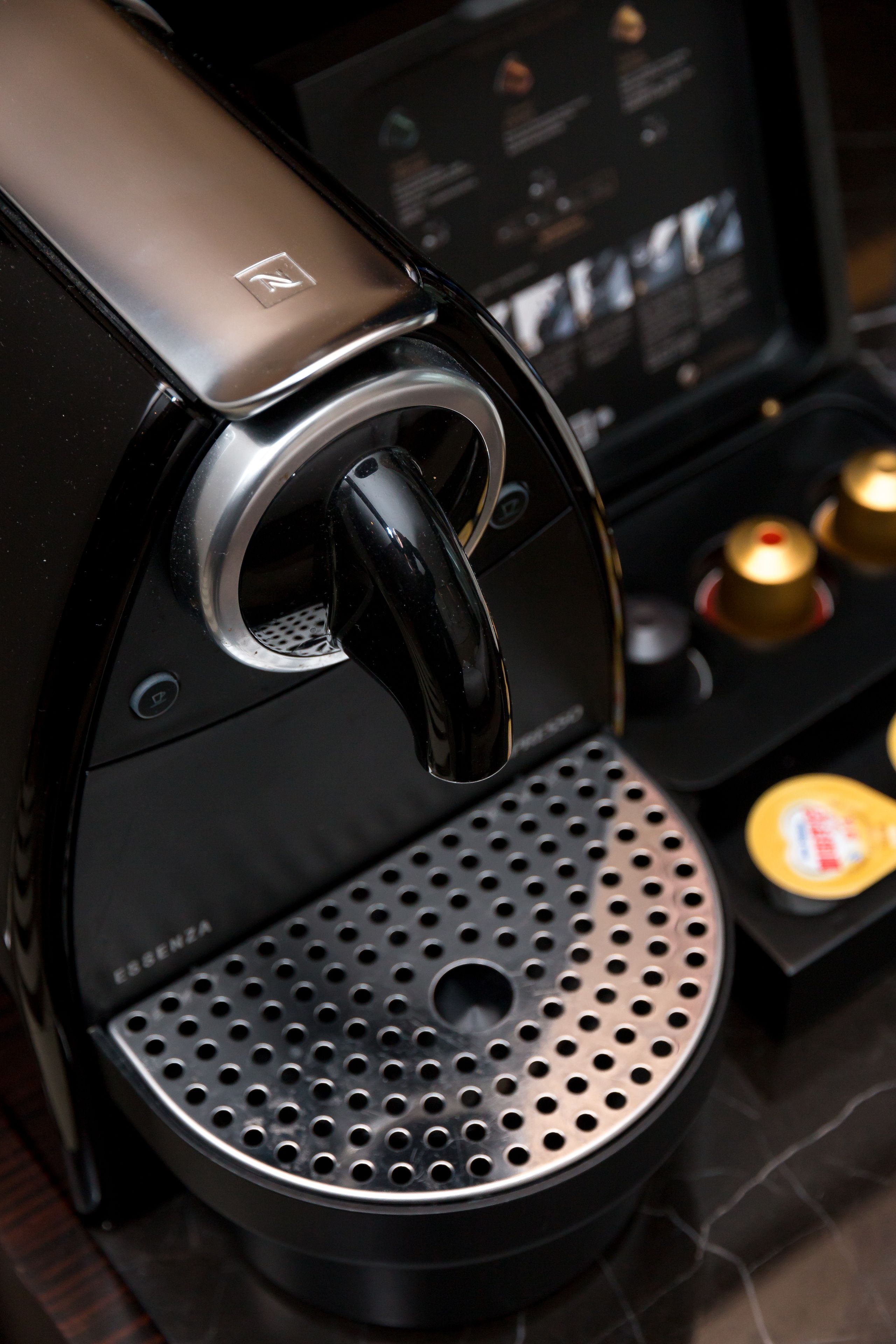 A coffee machine with a digital display and a control panel.