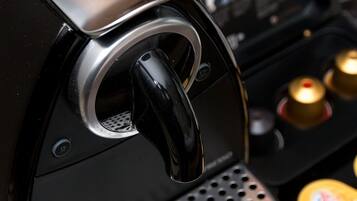 A coffee machine with a digital display and a control panel.