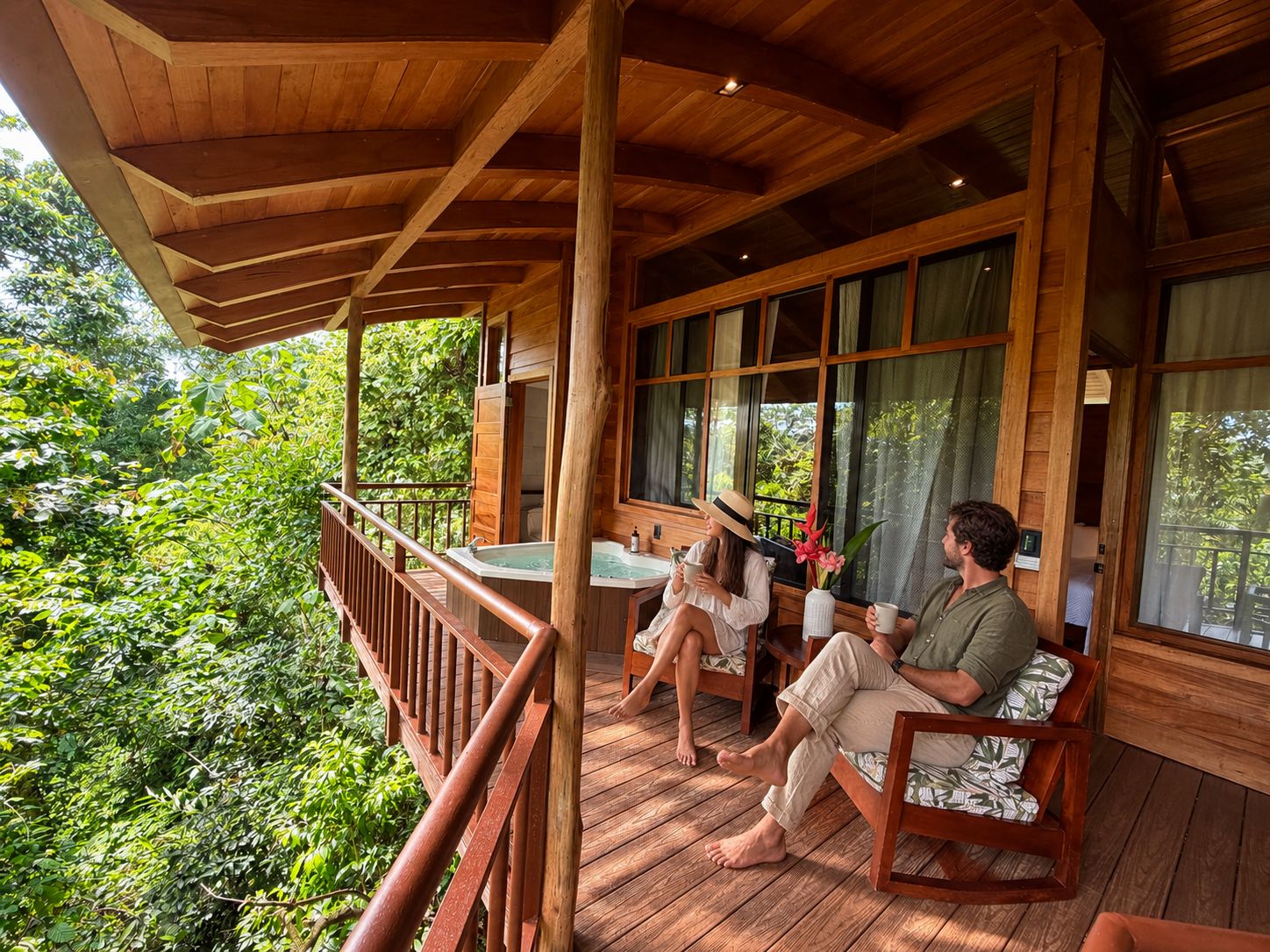 A wooden deck with a view of lush greenery, a hot tub, and a seating area with a table.