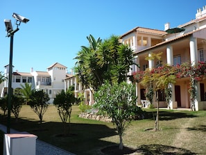 A residential area with multiple houses, a street lamp, and well-maintained gardens. - Old Village Apartamentos Ov International (Loulé)