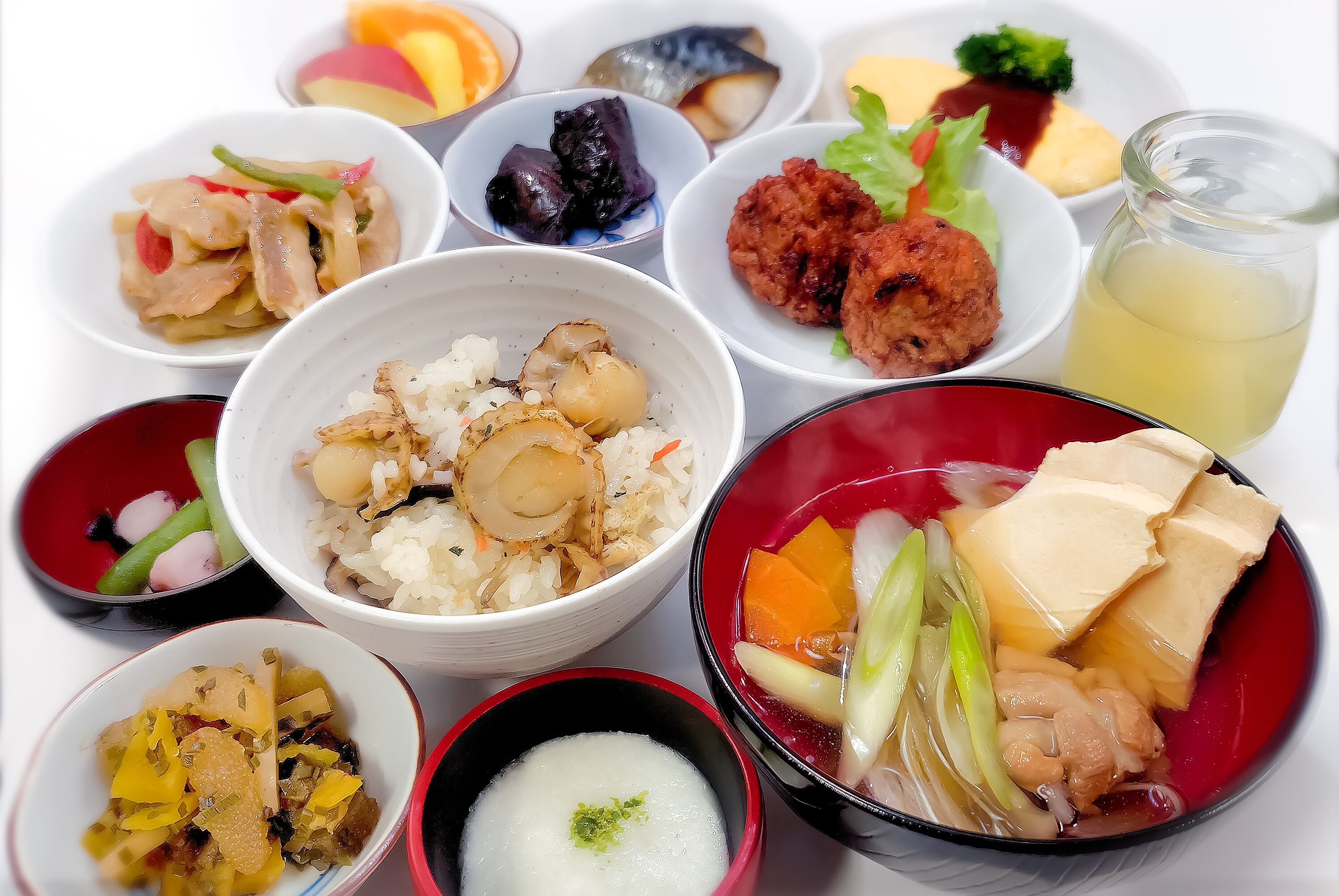 A variety of dishes including rice, tofu, and vegetables, suggesting a meal setting.