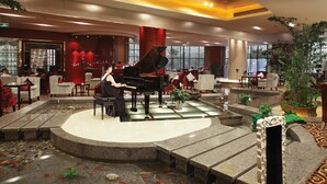 A spacious lobby with a grand piano, seating areas, and a koi fish pond. - Yuloon Hotel Shanghai (Shanghai)