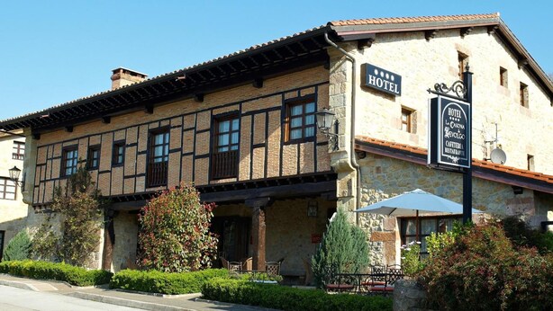 A traditional stone building with a sign indicating it is a hotel. - La Casona de Revolgo (Santillana del Mar)