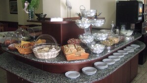 A buffet setup with various food items and serving dishes. - Innocenti (Montecatini Terme)