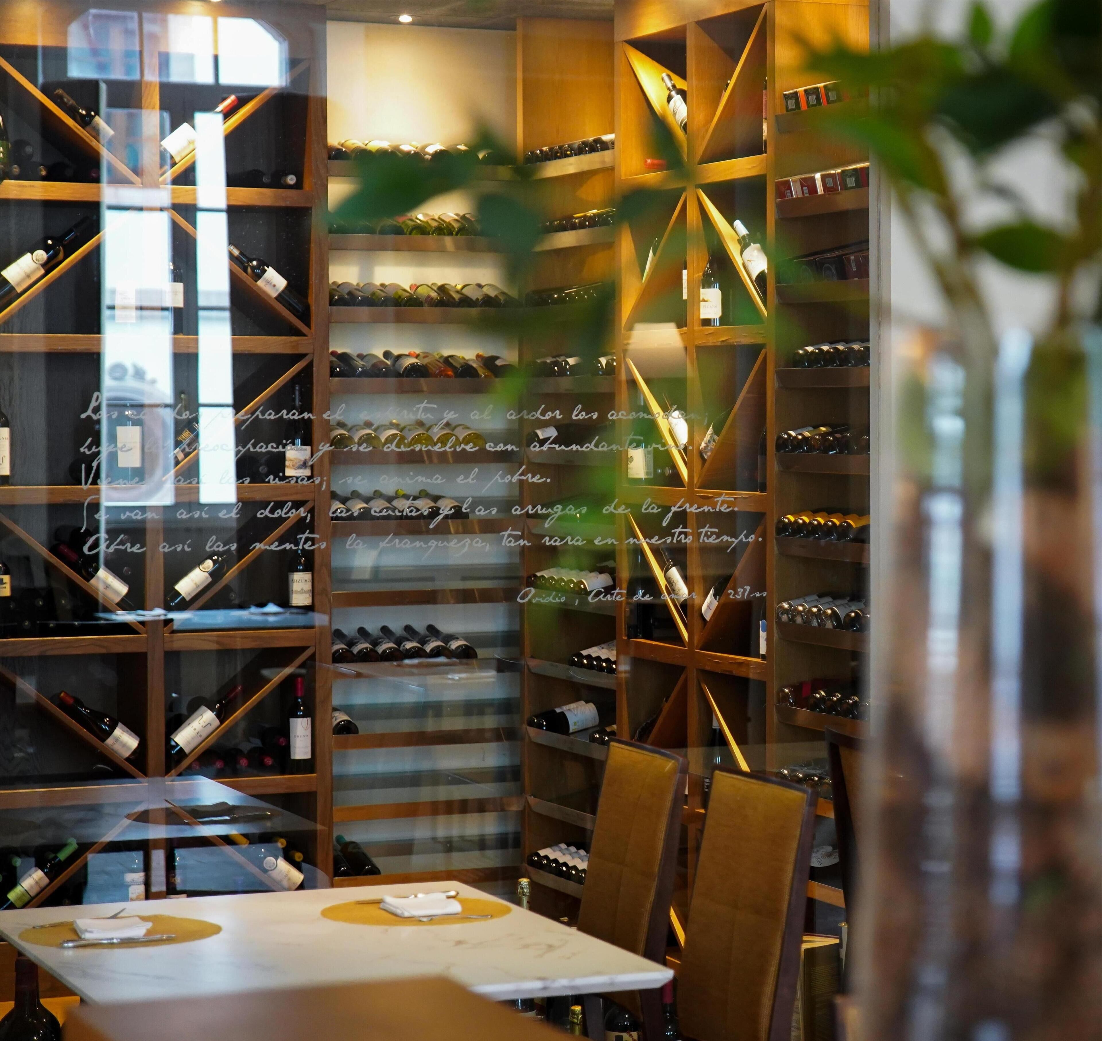 A wine cellar with wooden shelves and a table with a napkin and a knife.