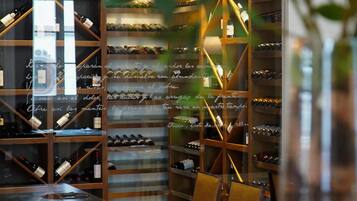 A wine cellar with wooden shelves and a table with a napkin and a knife.
