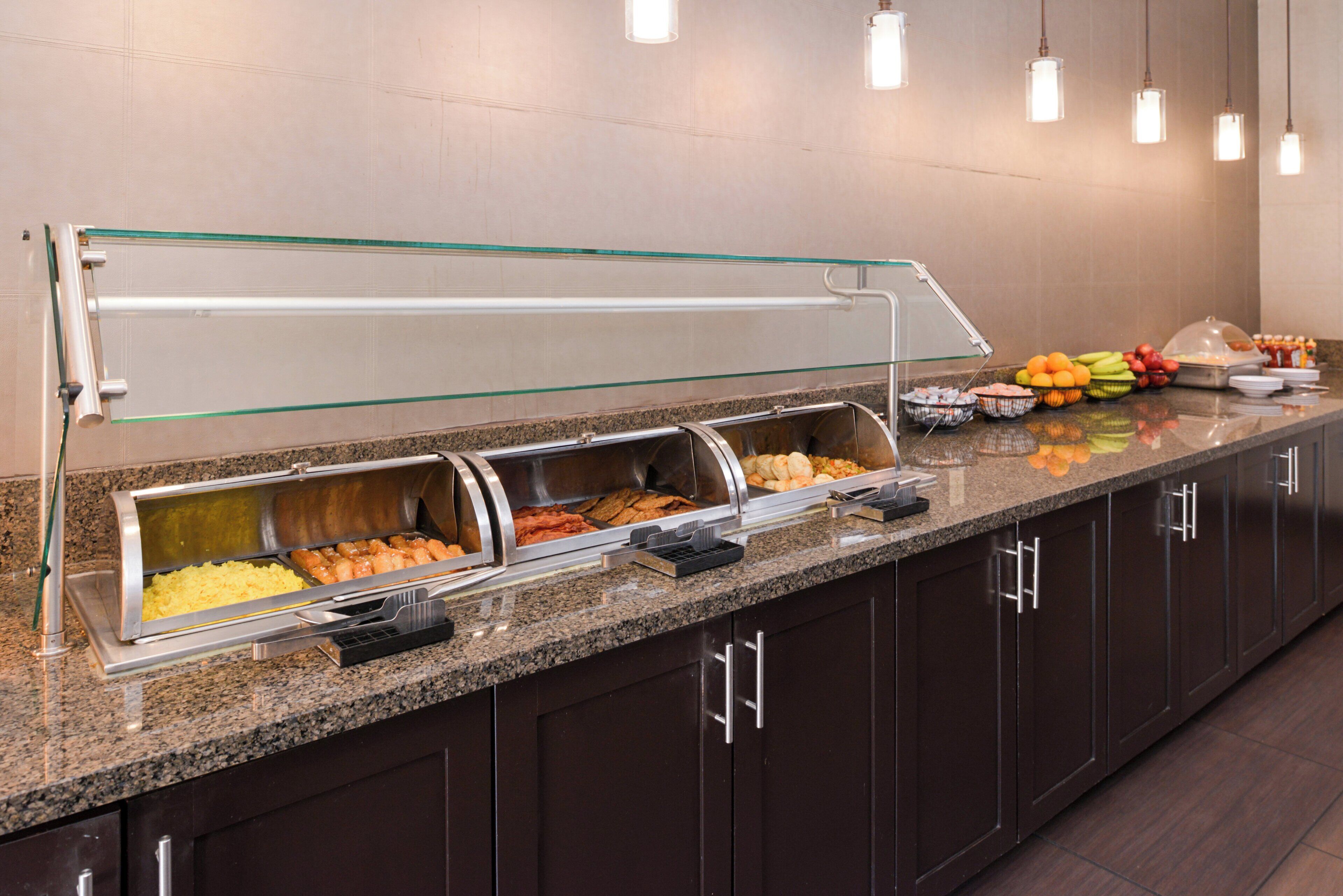 A buffet area with multiple food stations, including a salad bar and a hot food section.
