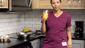 A kitchen with wooden cabinets, a stainless steel refrigerator, and a coffee maker. - Candlewood Suites Decatur Medical Center by IHG (Decatur)