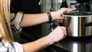 A person using a smart kitchen appliance with a digital display, a water dispenser, and a coffee maker. - Candlewood Suites Decatur Medical Center by IHG (Decatur)
