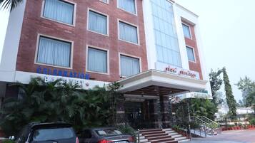 A hotel with a brick facade, large windows, and a sign that reads "Celebration".