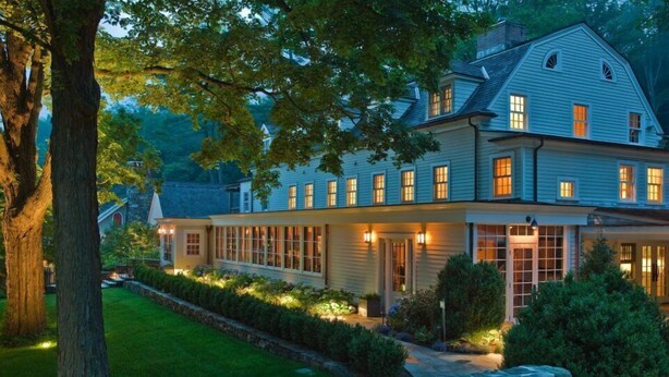 A large, two-story house with a covered porch and multiple windows. - Bedford Post Inn (Bedford)