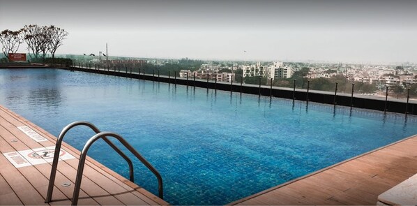 Seasonal outdoor pool, pool loungers