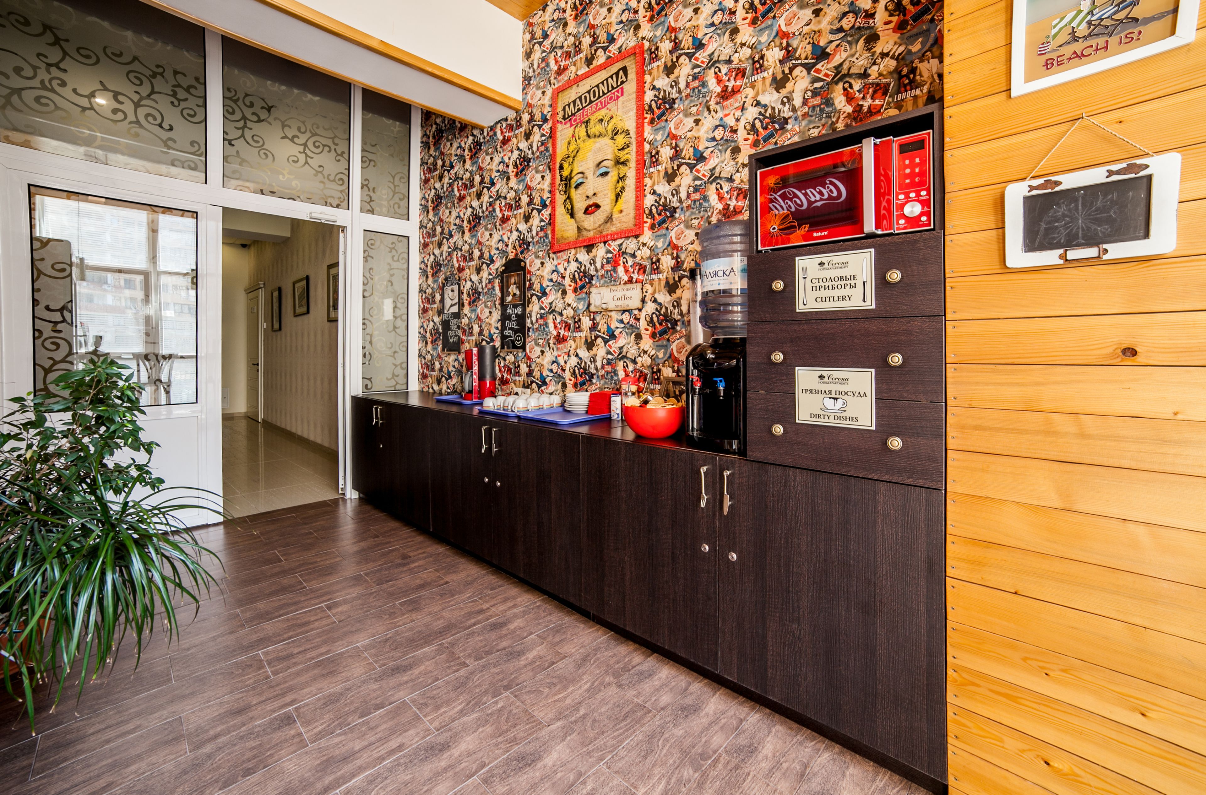 A kitchen with dark wooden cabinets, a tiled backsplash, and various appliances.