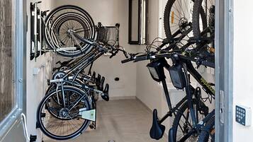 A hallway with bicycles mounted on a wall and a door.