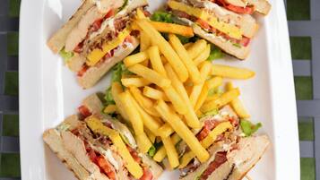 A plate of sandwiches and french fries.