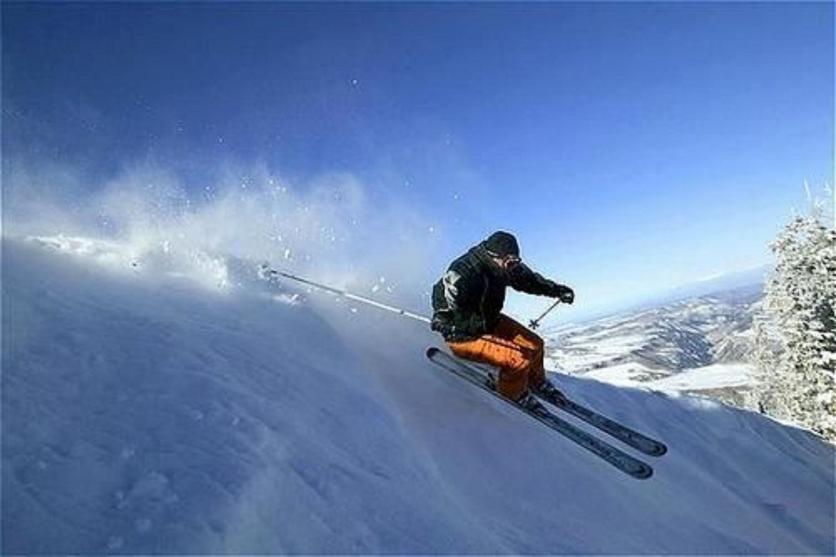 A person skiing down a snow-covered slope.
