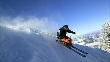 A person skiing down a snow-covered slope.