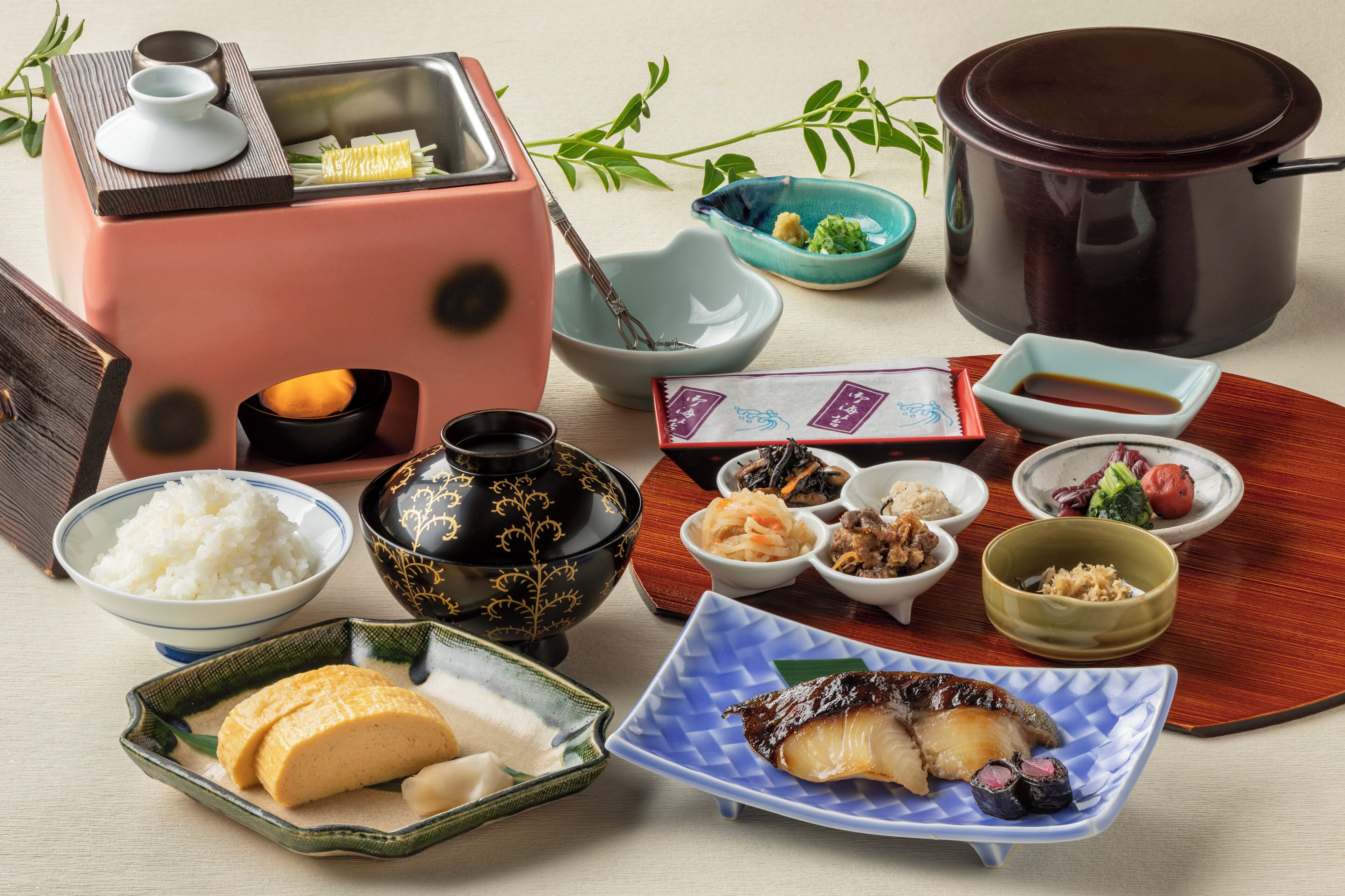 A traditional Japanese meal setup with various dishes and utensils.