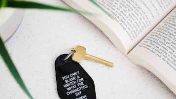 A book with a bookmark and a keychain with a quote.