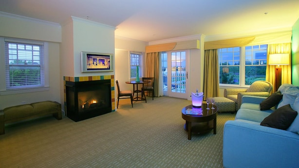 A living room with a fireplace, a sofa, a coffee table, and a TV.
