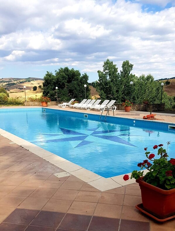 Seasonal outdoor pool, pool umbrellas, pool loungers