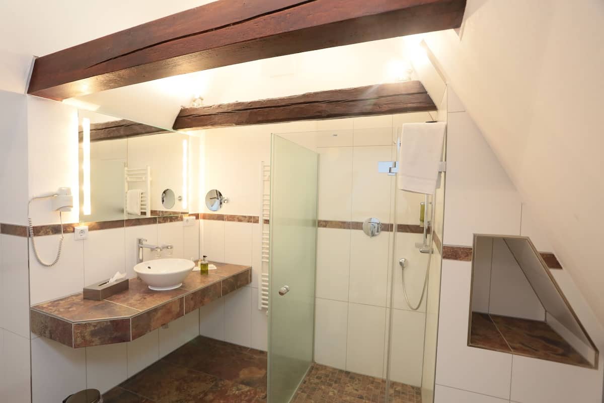 junior suite | bathroom | shower, free toiletries, hair dryer, bathrobes