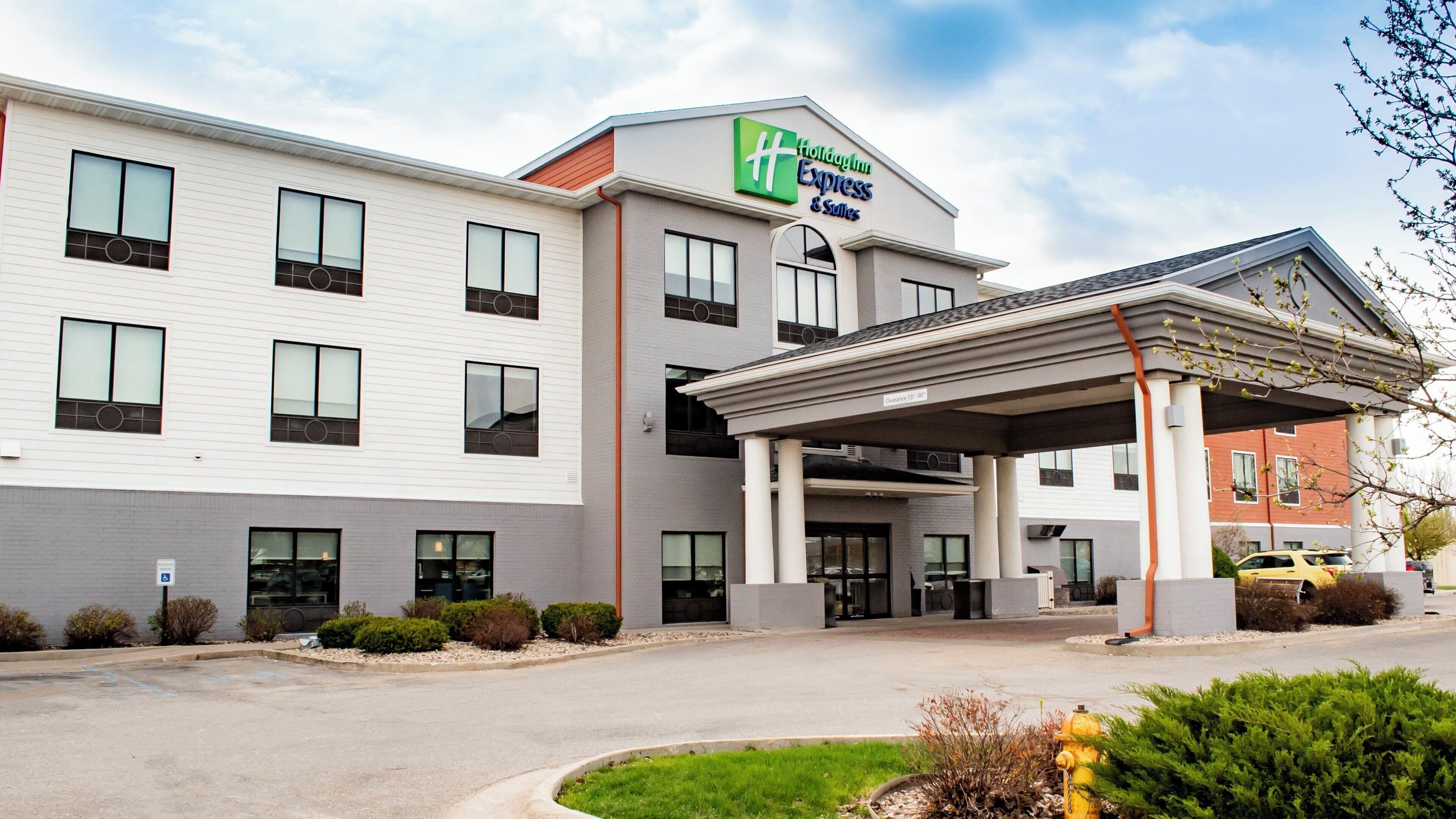 A Holiday Inn Express building with a covered entrance, multiple windows, and a parking lot.