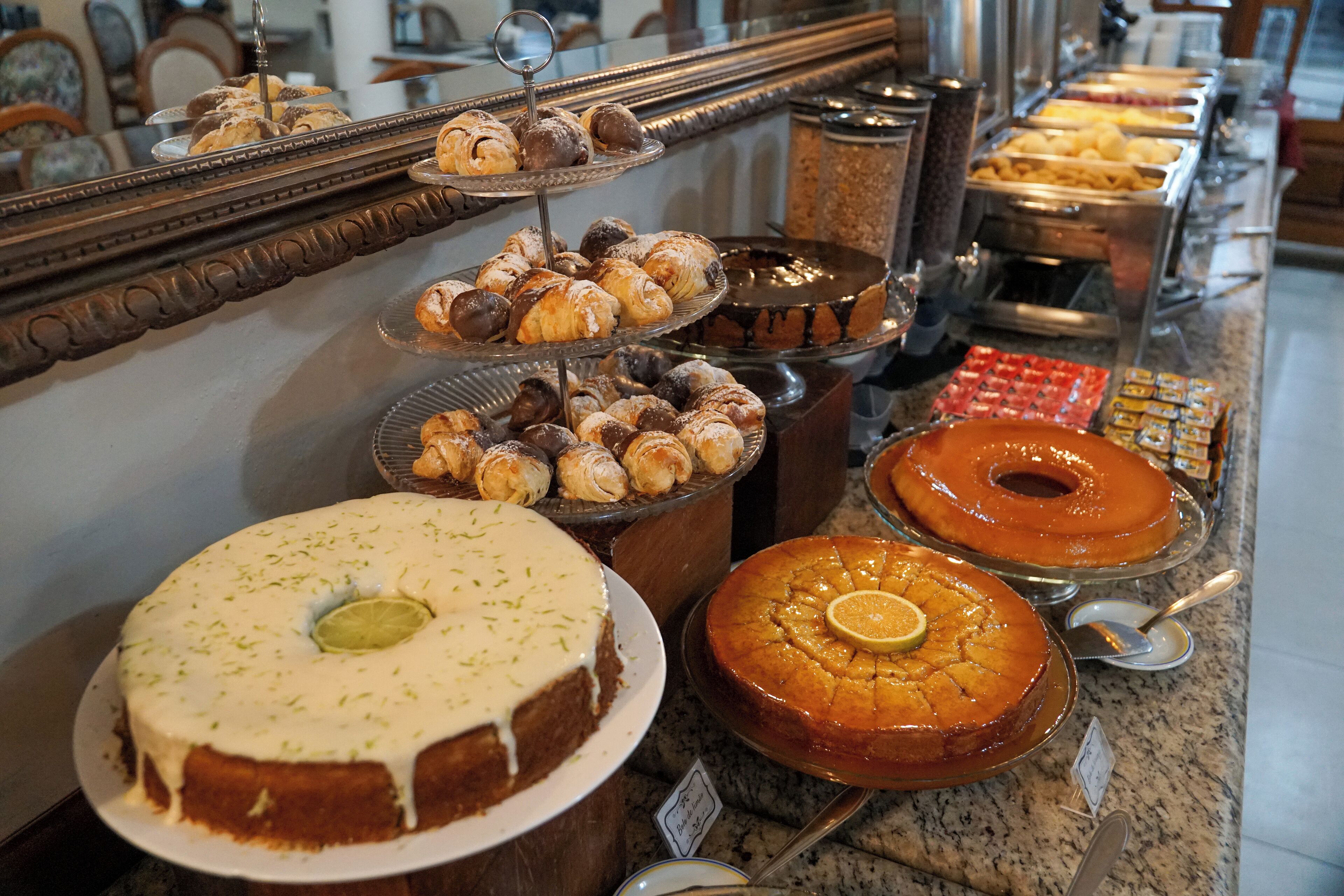 A buffet with various desserts including cakes and pastries.