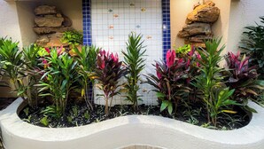 Un jardín con un muro de azulejos y un cartel que dice 'JARDIM ATLANTICO'.