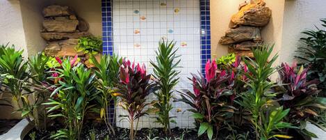 Un jardín con un muro de azulejos y un cartel que dice 'JARDIM ATLANTICO'.